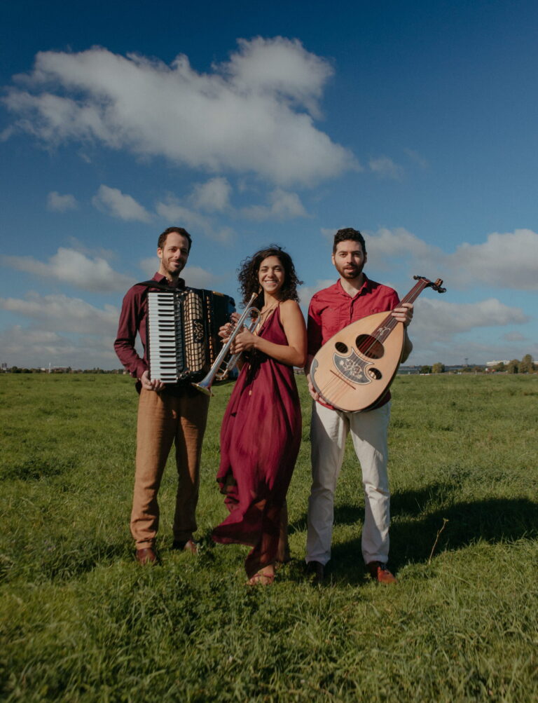 Ira Shiran with accordeon, Yael Gat with trumpet and Doron Furman with oud on grassland